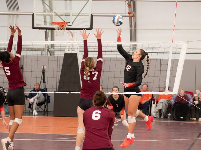 Players going up at the net during a volleyball match