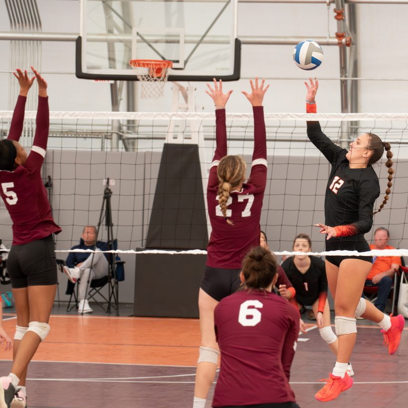 Players going up at the net during a volleyball match